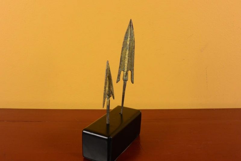 2 arrowheads on a metal base 3