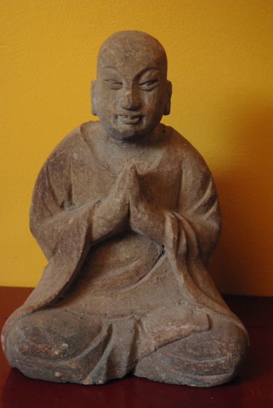 Statue of a Buddhist monk in prayer position 1