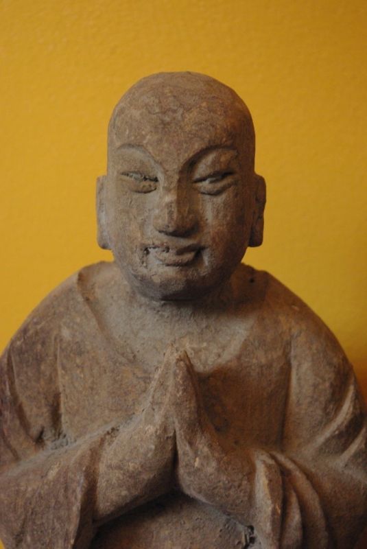 Statue of a Buddhist monk in prayer position 2